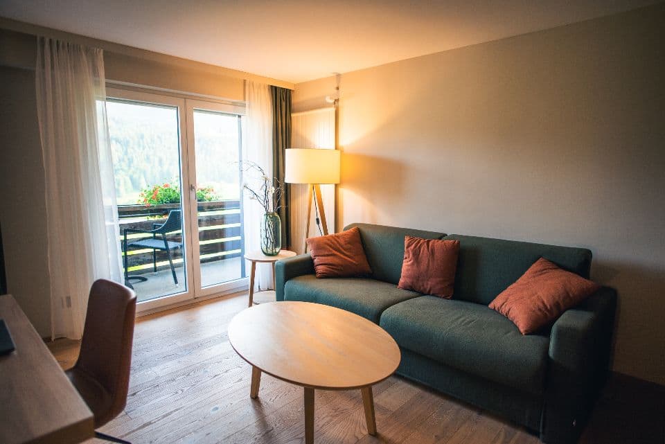 A warm apartment living room opening onto a balcony