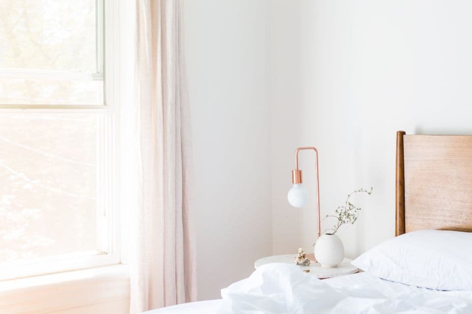 A bright bedroom with freshly made white linen